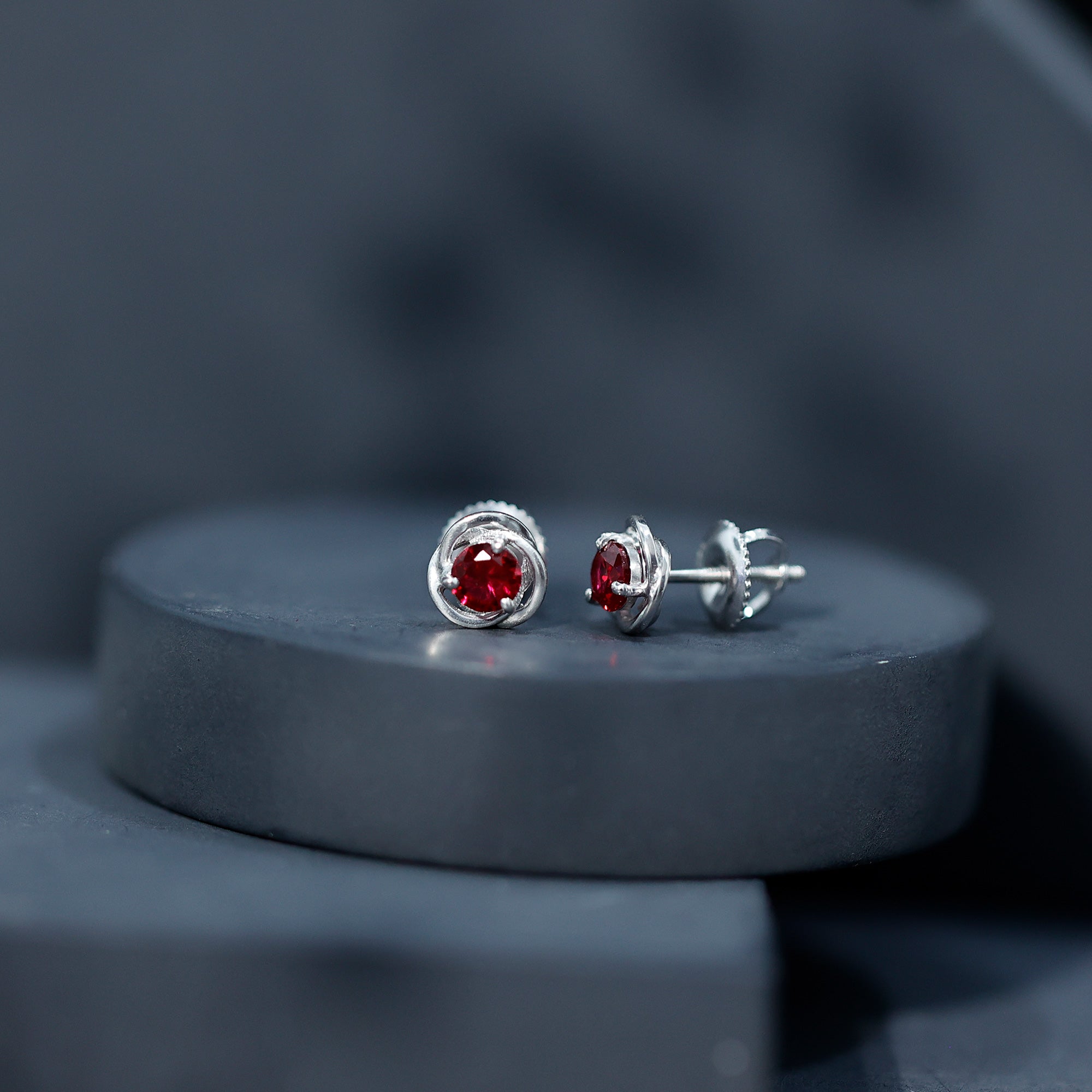 Solitaire Created Ruby Swirl Stud Earrings in 3 Prong Setting