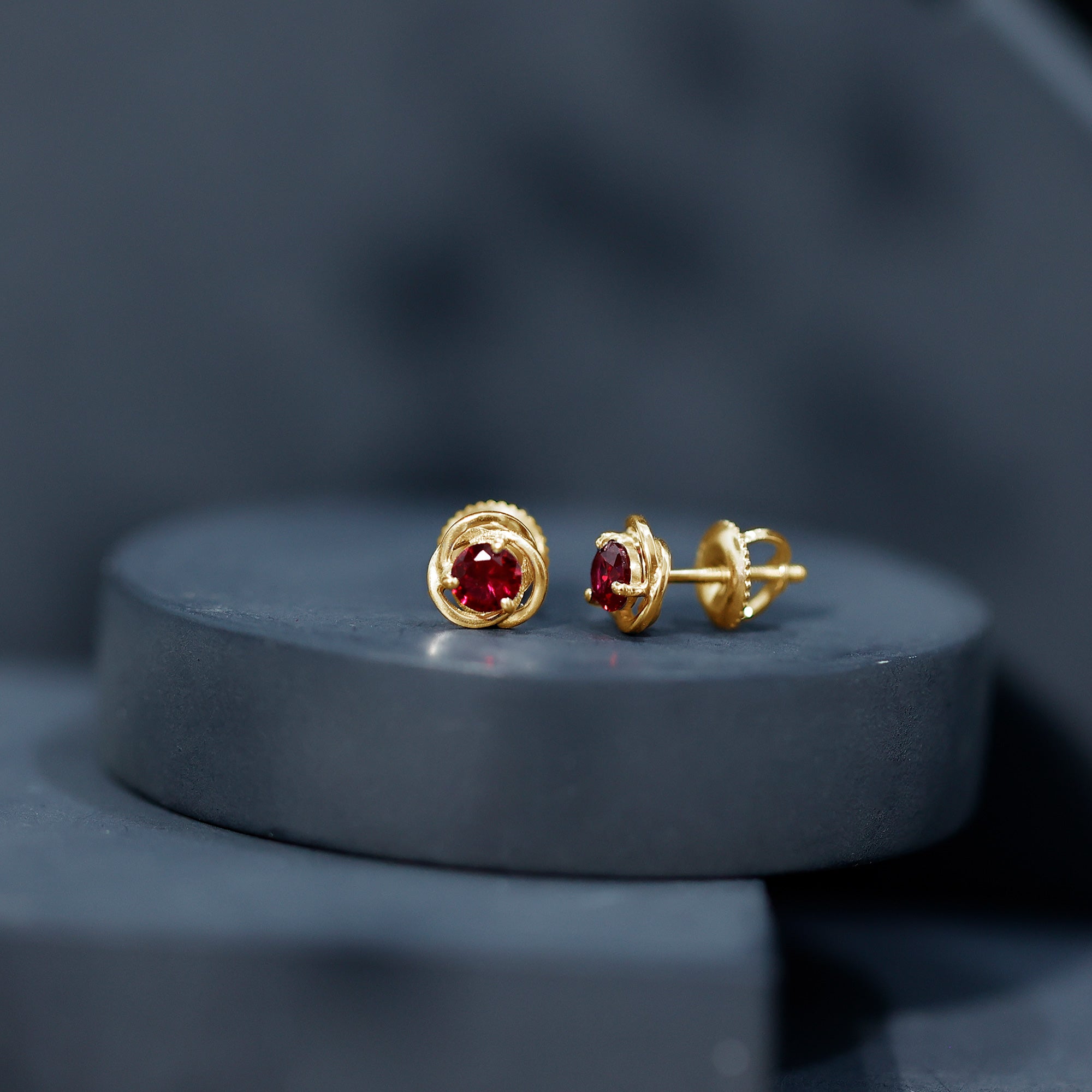 Solitaire Created Ruby Swirl Stud Earrings in 3 Prong Setting