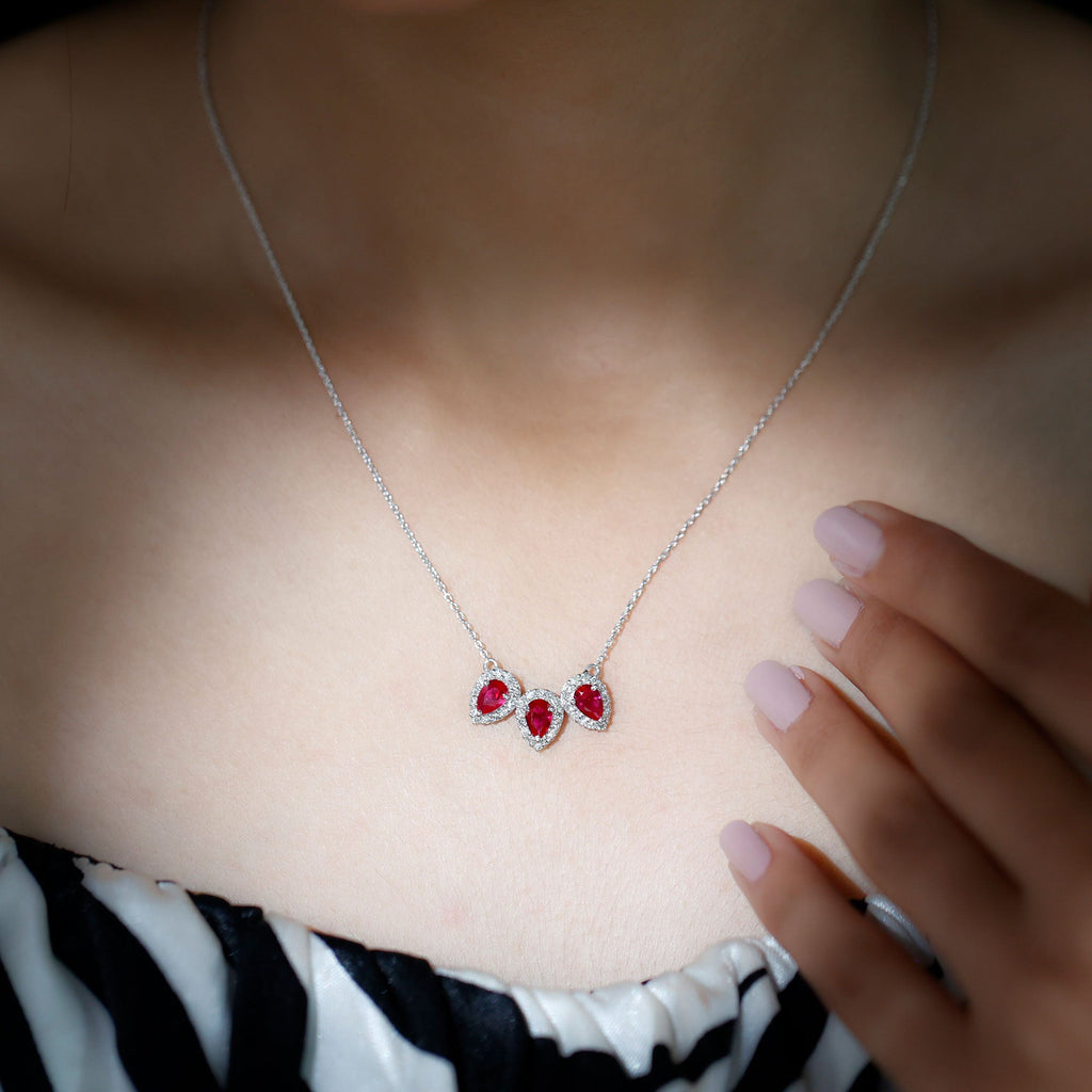 Pear Cut Lab Created Ruby Three Stone Necklace with Moissanite Halo