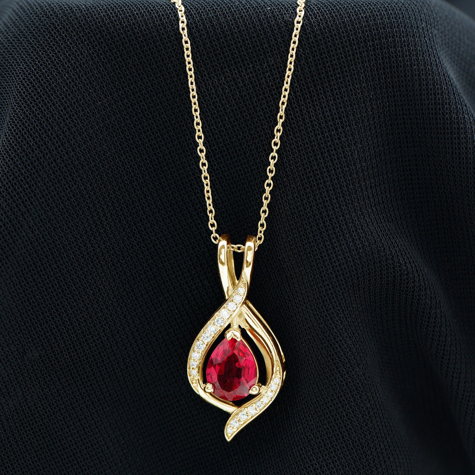 Pear Cut Created Ruby Teardrop Pendant with Moissanite Accent