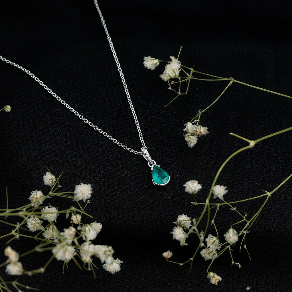 3/4 CT Pear Cut Emerald Solitaire Pendant in Half Bezel Setting with Diamond Accent Bail