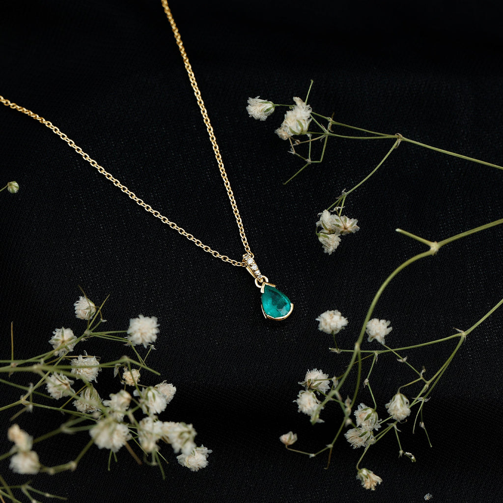 3/4 CT Pear Cut Emerald Solitaire Pendant in Half Bezel Setting with Diamond Accent Bail