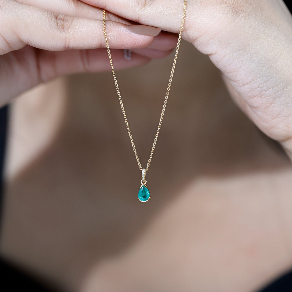 3/4 CT Pear Cut Emerald Solitaire Pendant in Half Bezel Setting with Diamond Accent Bail