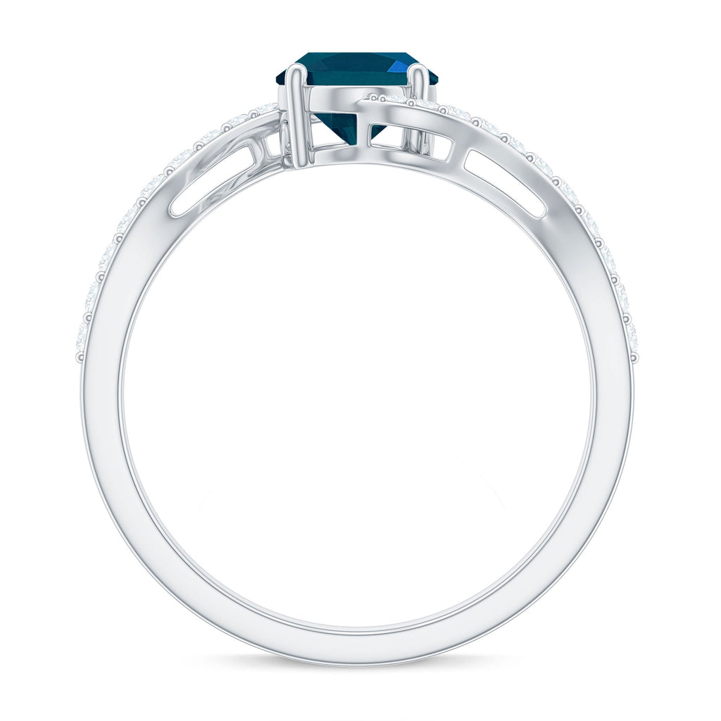6X8mm Oval Cut London Blue Topaz and Diamond Bypass Engagement Ring