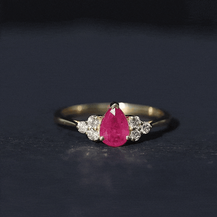 Claw Set Pear Cut Ruby Engagement Ring with Diamond Trio