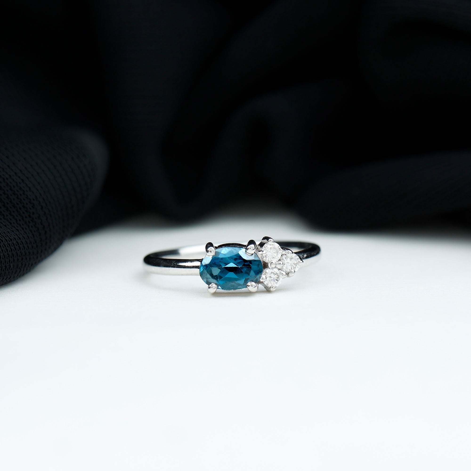 4X6mm Oval Cut London Blue Topaz East West Promise Ring with Diamond Trio