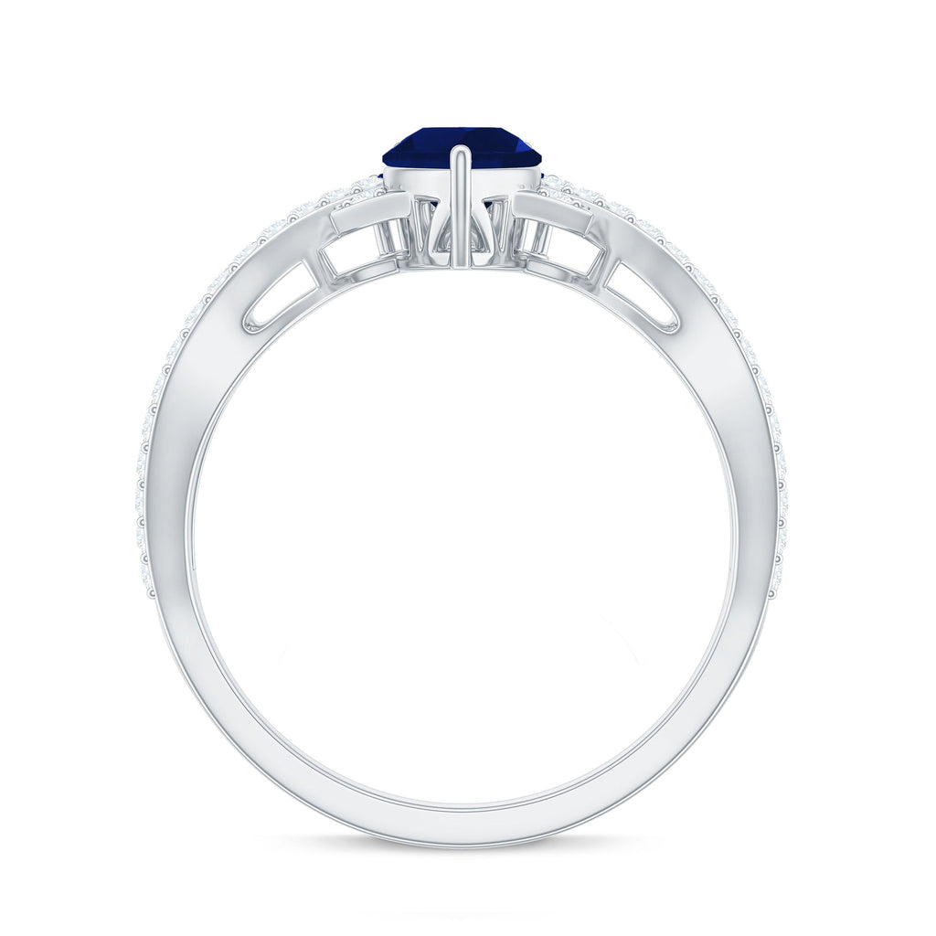 Pear Cut Blue Sapphire and Diamond Crossover Engagement Ring